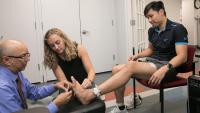 Dr. Rao working with a student and a patient.